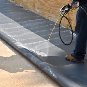 Close up of GAF PVC roofing system being installed onto commercial roof