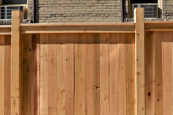Large wooden fence with condensed boards, allowing privacy